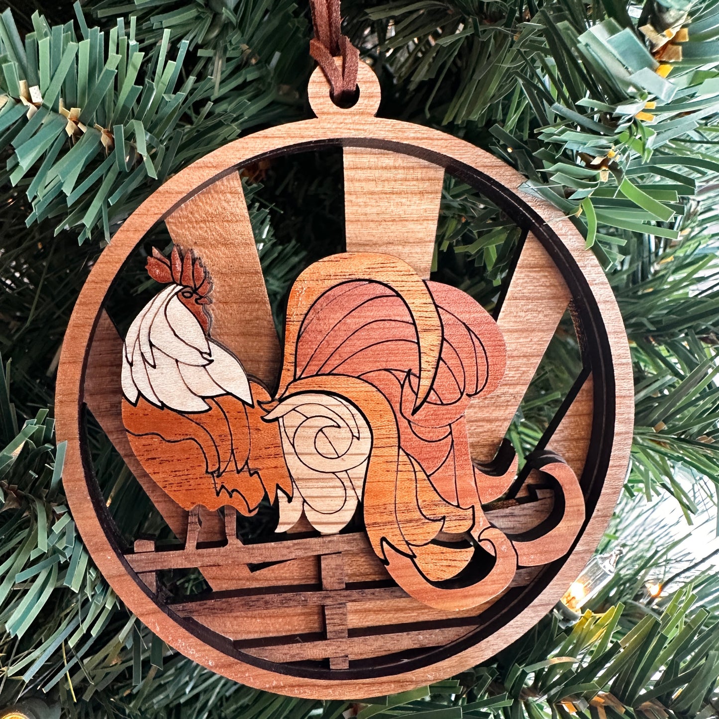 Layered wooden rooster ornament made with multiple species of wood.