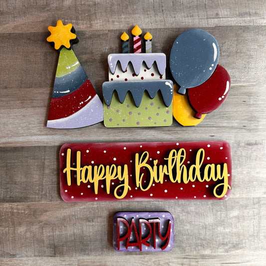 This is the Happy Birthday insert that goes with our Vintage Truck. It shows a Birthday party hat, cake, and balloons, which slide into the back of the truck's rails. The tailgate reads 'Happy Birthday,' and the license plate reads 'Party.' These items include Velcro dots, allowing them to adhere to the Velcro on the truck base. All of these items are hand-painted with love.